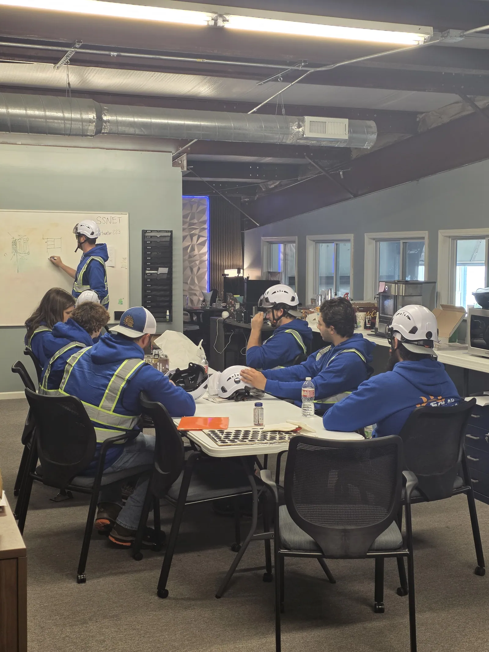 The Solar Shield Blinds crew planning a commercial installation at the shop