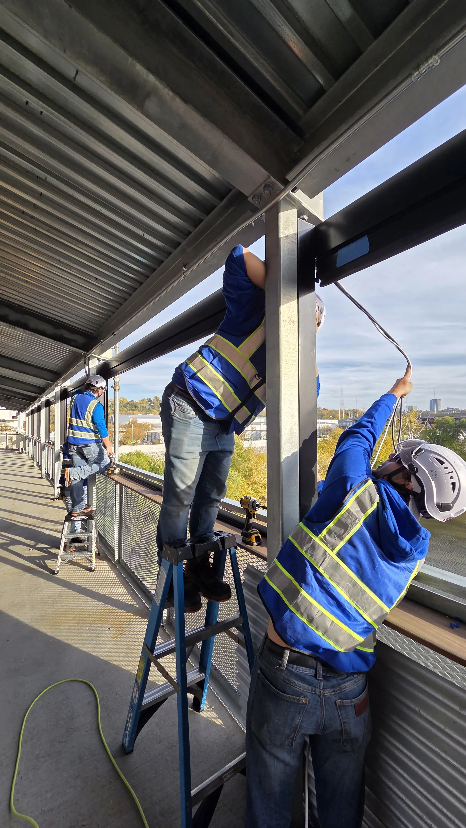 Feeding the motor cable up to the header on the outside face of the bridge
