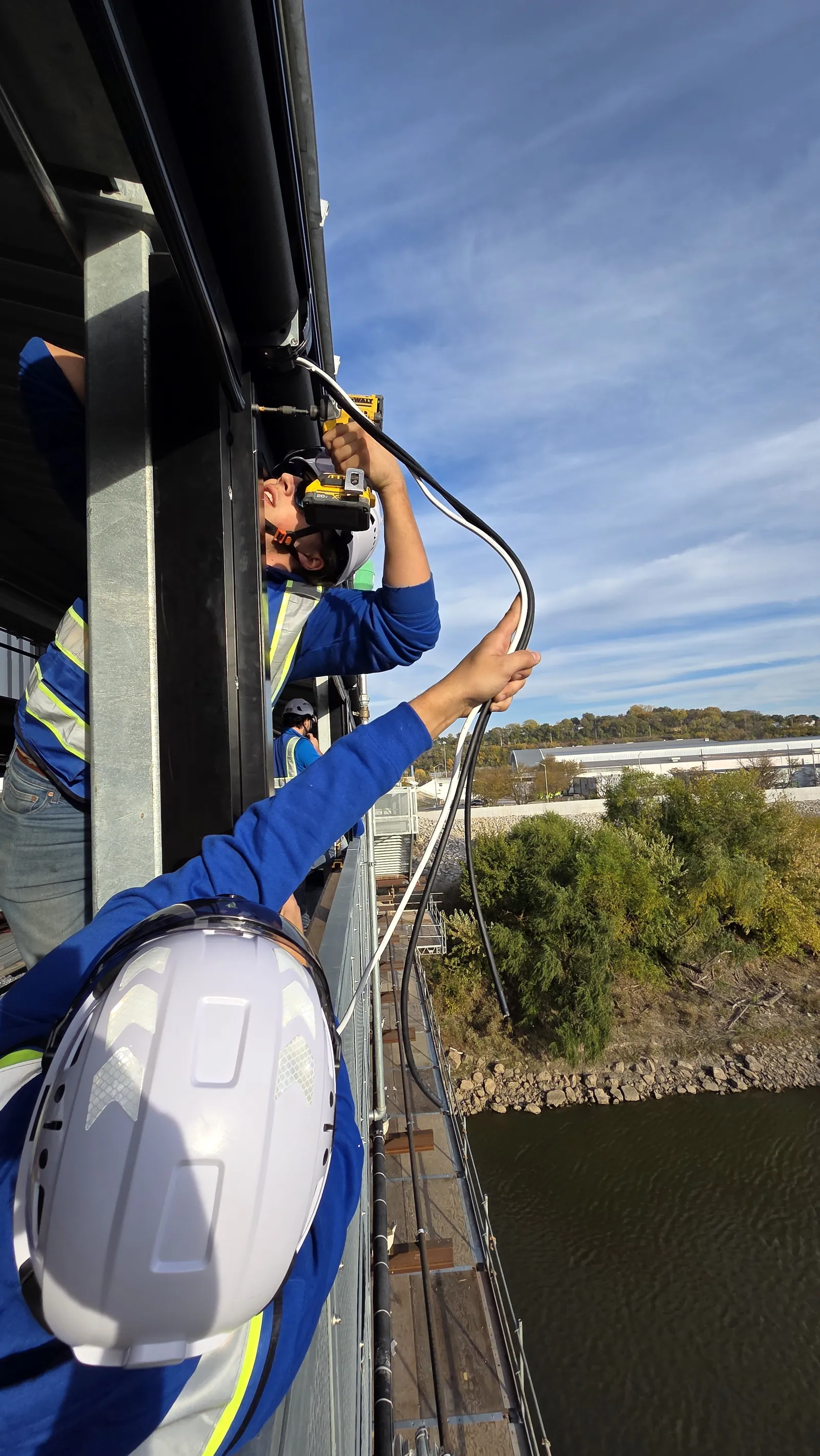 Running the motor cable for an exterior screen out over the Kansas River