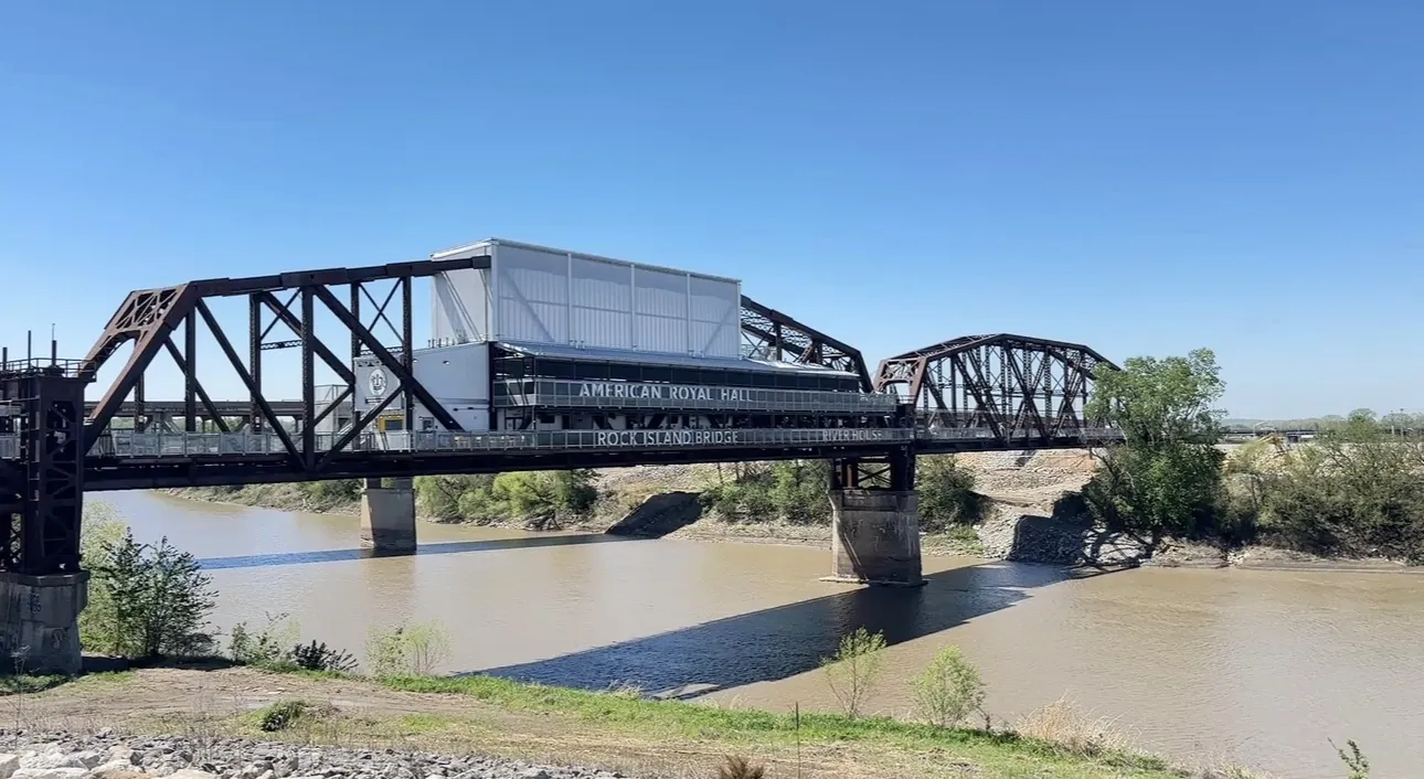 The finished Rock Island Bridge seen from the riverbank, shades fitted along the upper deck
