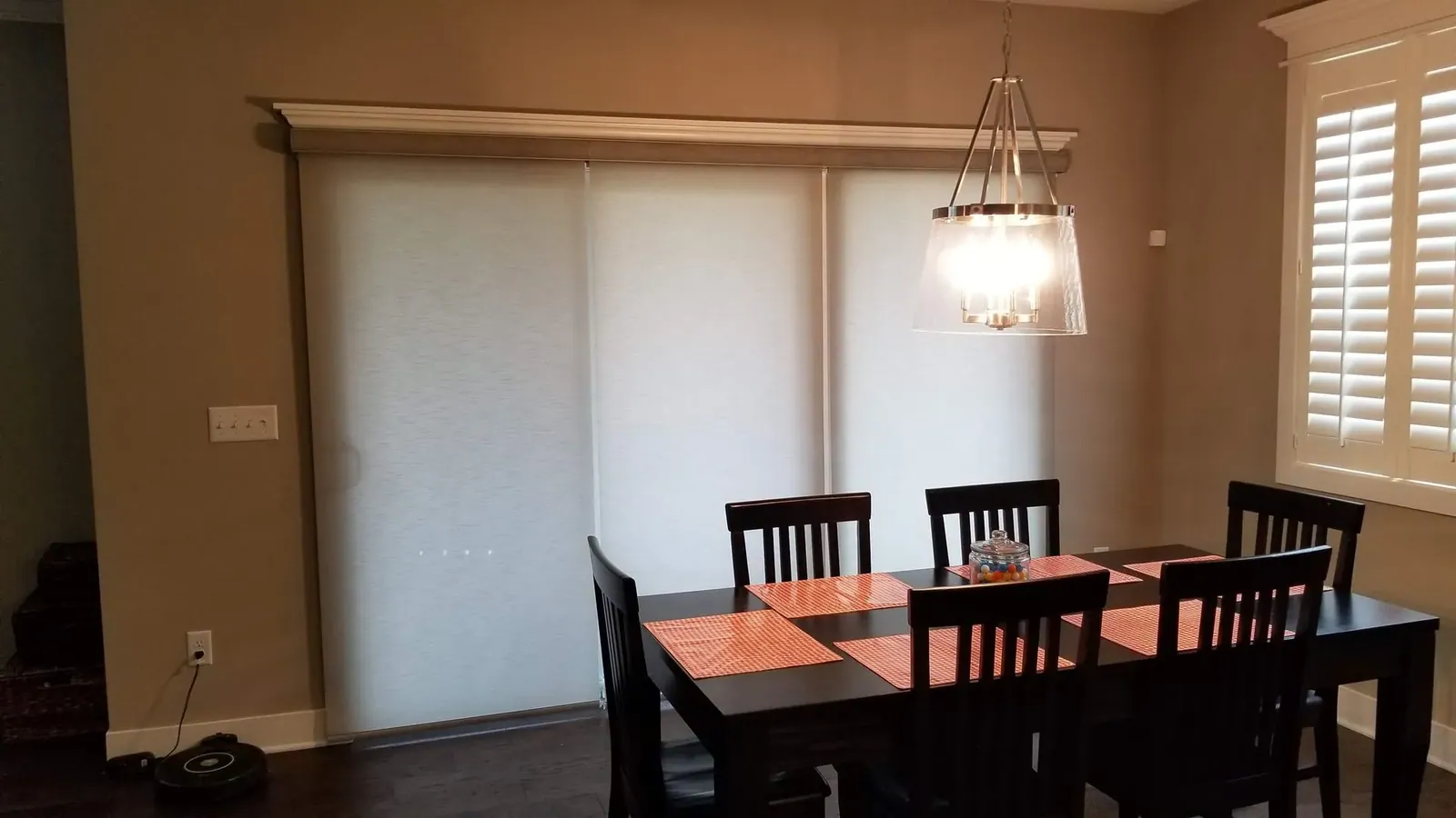 Roller Shades closed in a dining room, measured and hung by Solar Shield Blinds