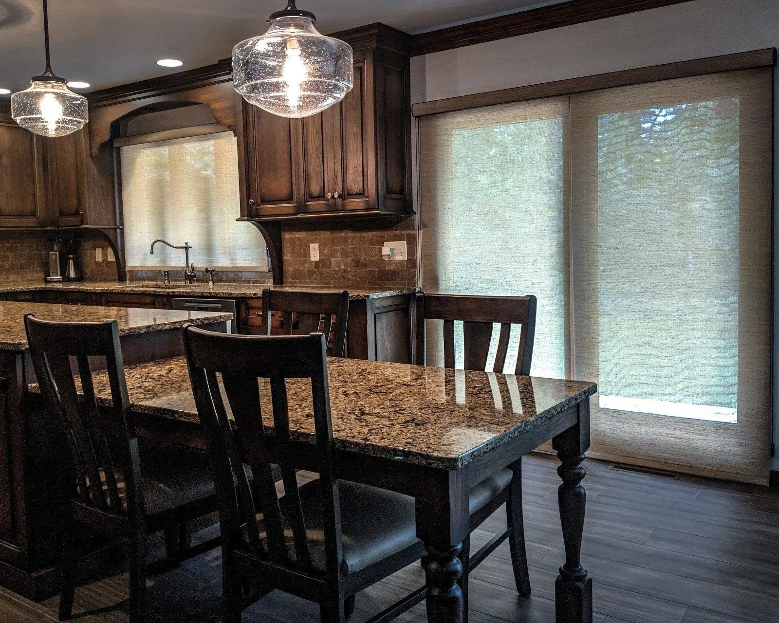 Roller Shades closed in a dining room kitchen, installed by Solar Shield Blinds