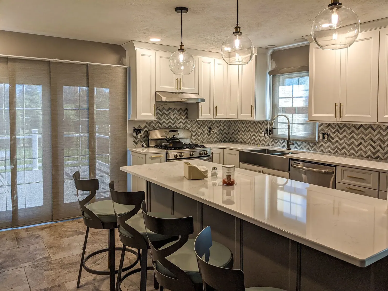 Custom roller shades closed in a kitchen, installed by Solar Shield Blinds