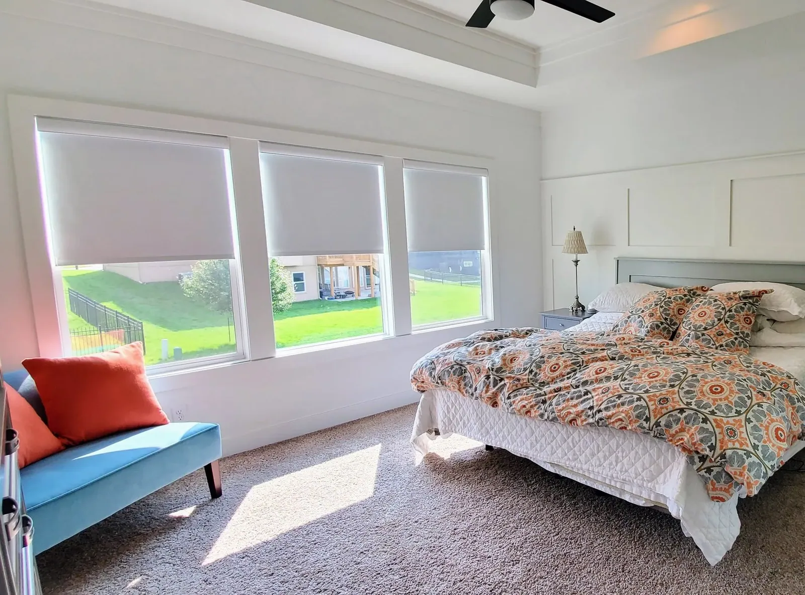 Roller Shades half closed in a bedroom, installed by Solar Shield Blinds