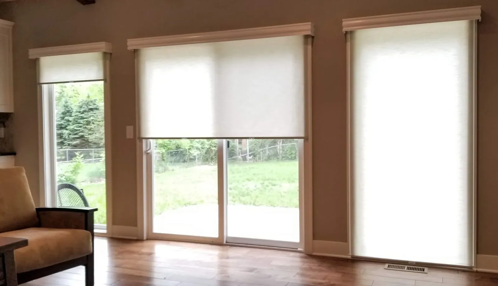 Roller Shades half closed on sliding glassdoor, installed by Solar Shield Blinds