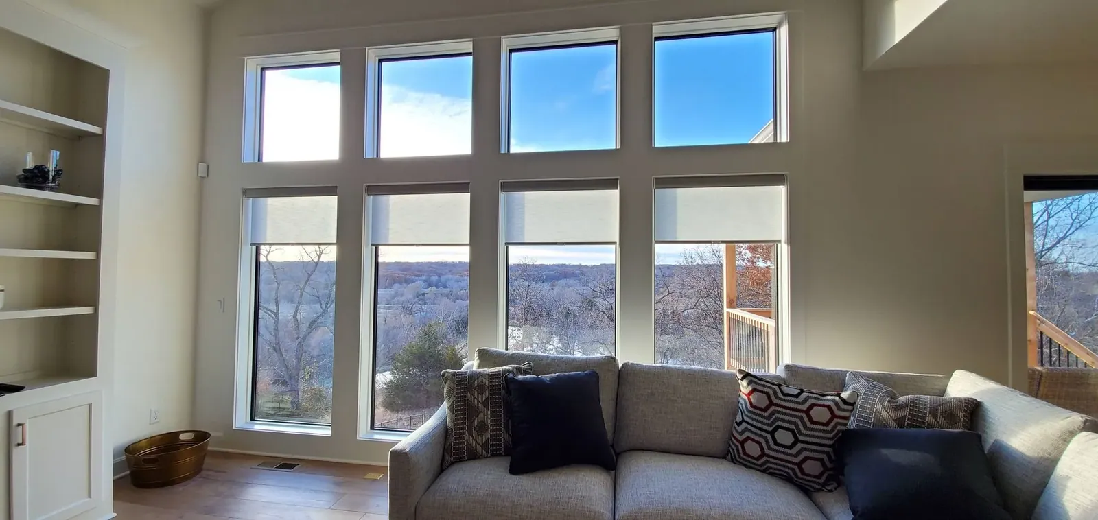 Roller Shades slightly closed in a living room, a Solar Shield Blinds install
