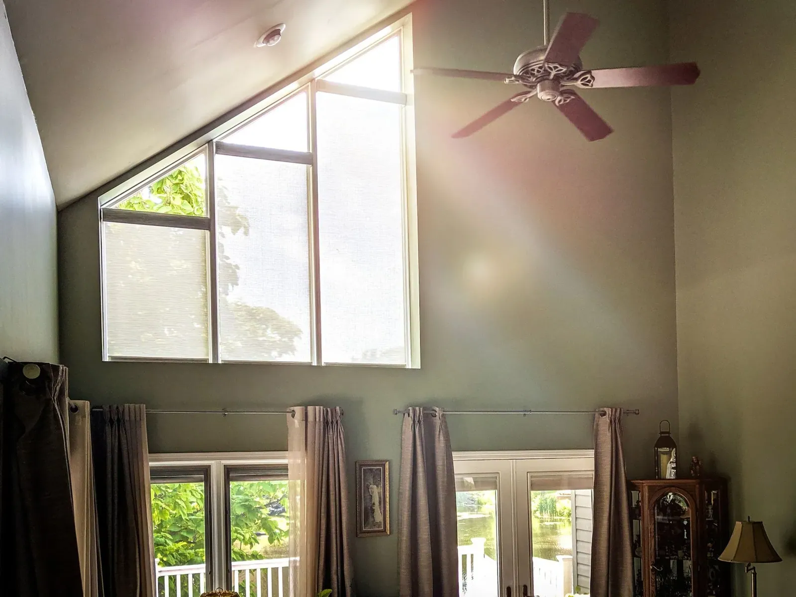 Roller Shades speciality shape in a living room, measured and hung by Solar Shield Blinds