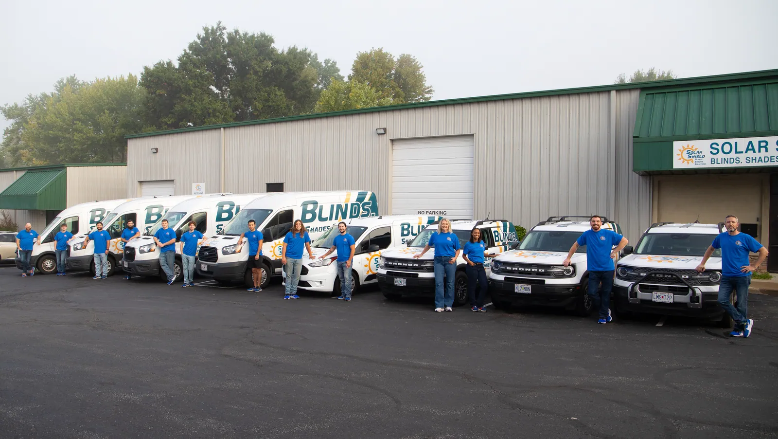The Solar Shield Blinds team with the service vehicles in Kansas City