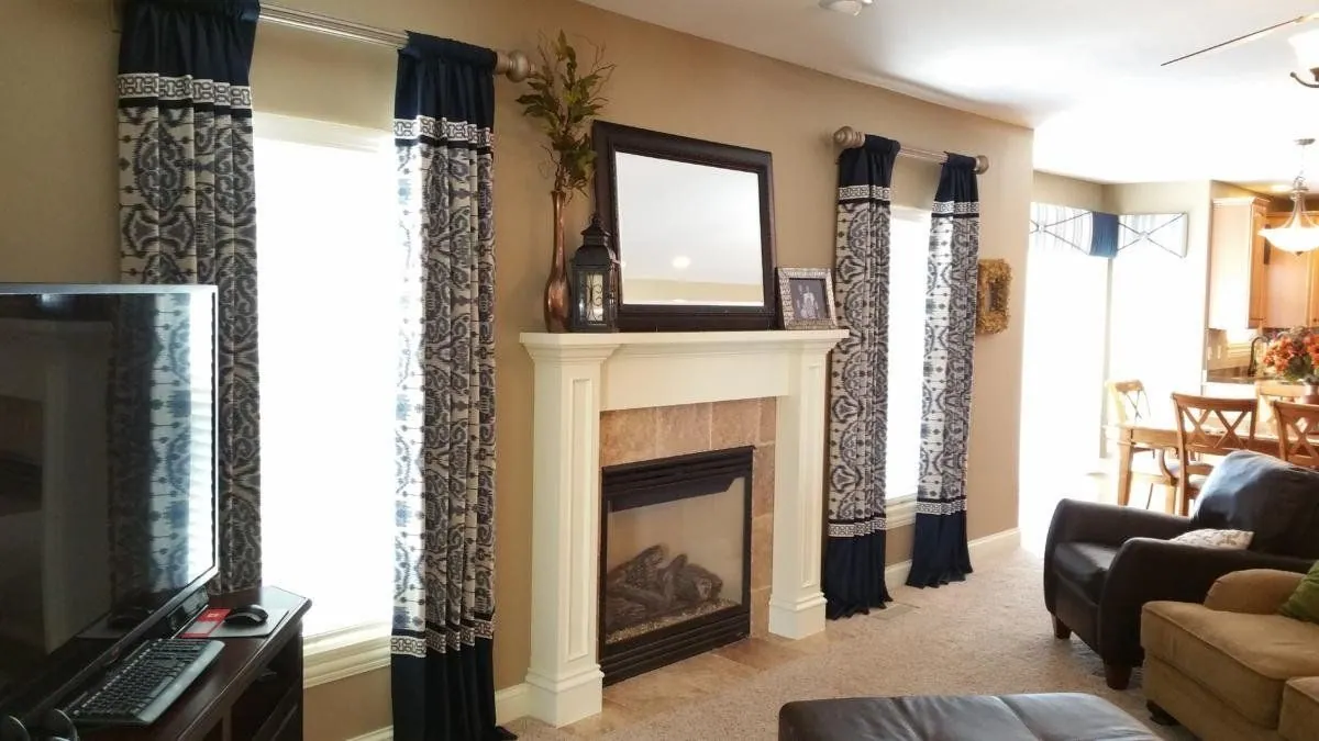 Patterned drapery panels on the windows beside a fireplace