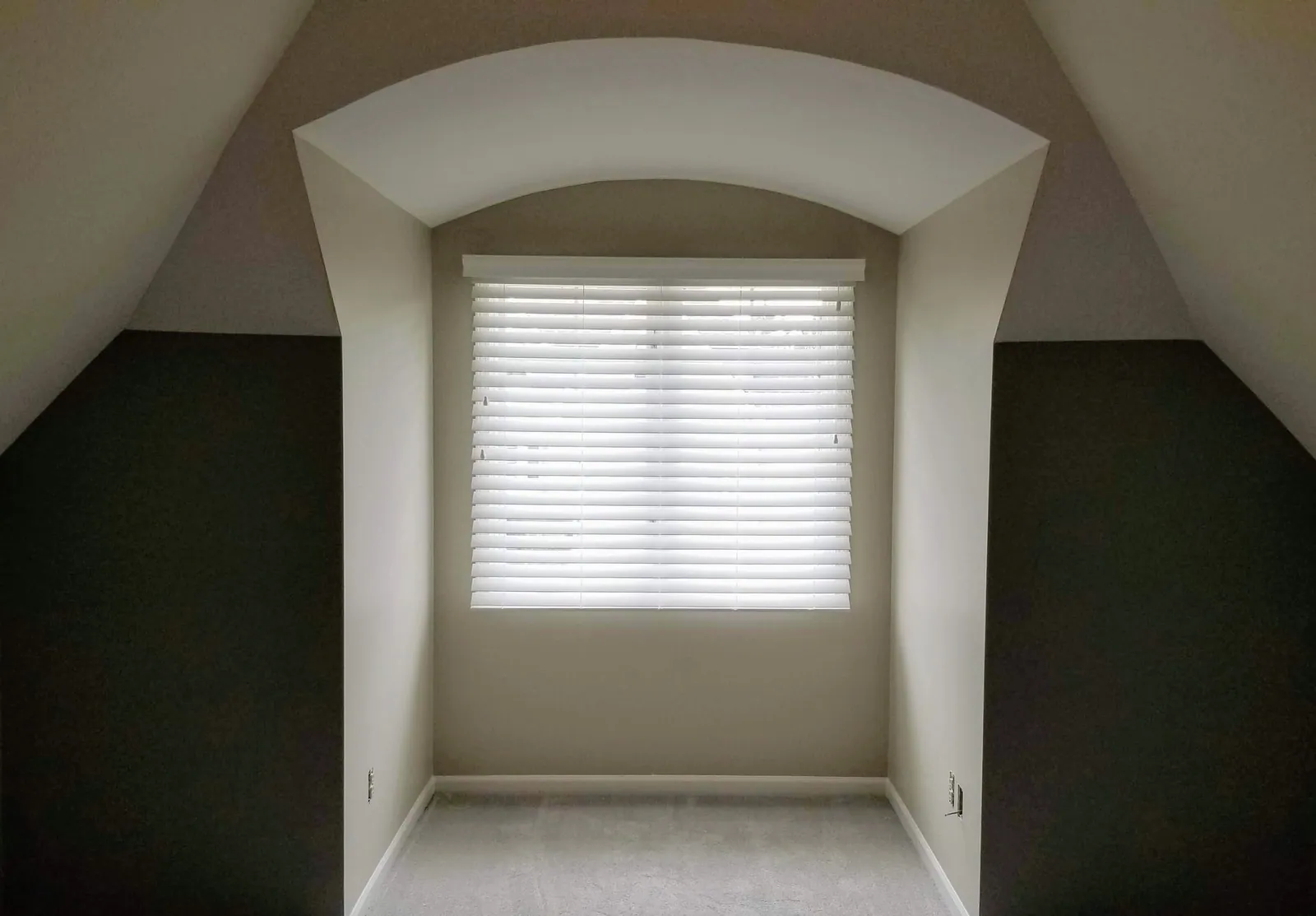 White blind on a window set into an arched alcove