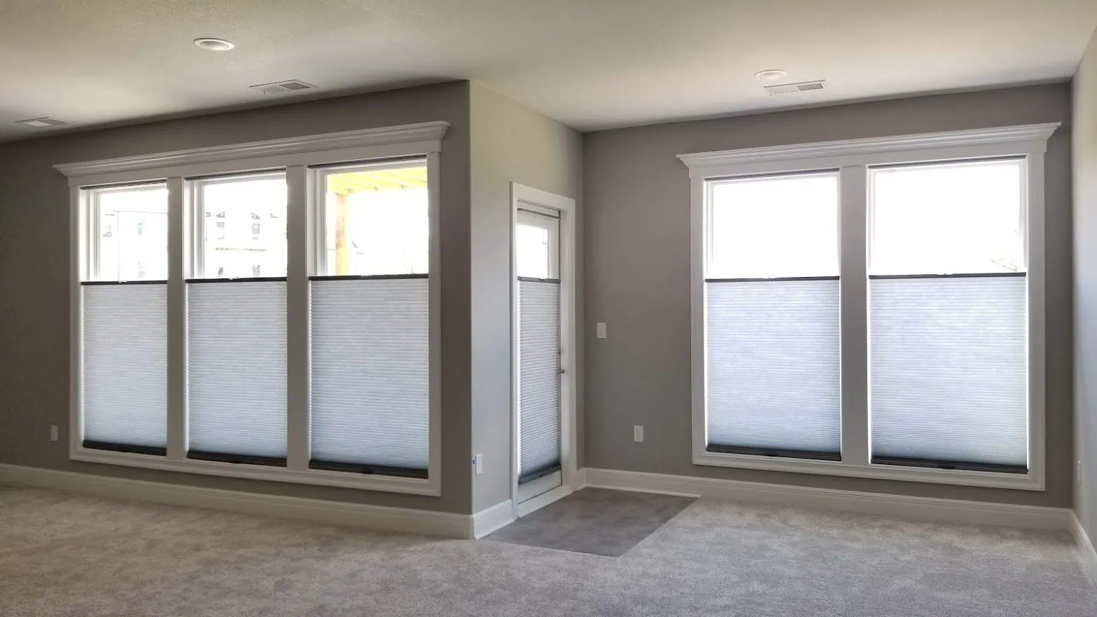 Honeycomb shades set top down bottom up on living room windows