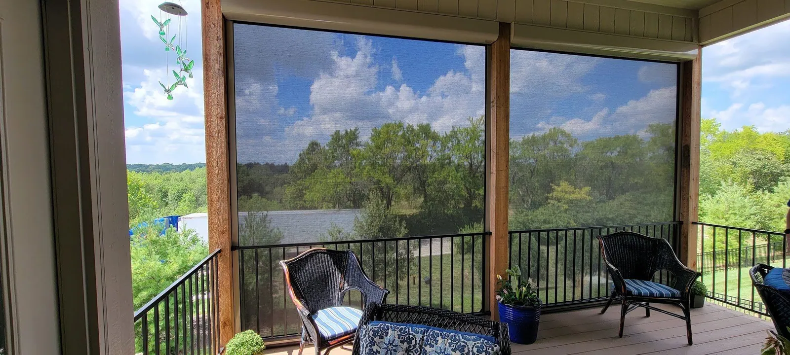 Exterior patio shade on a screened deck overlooking the trees