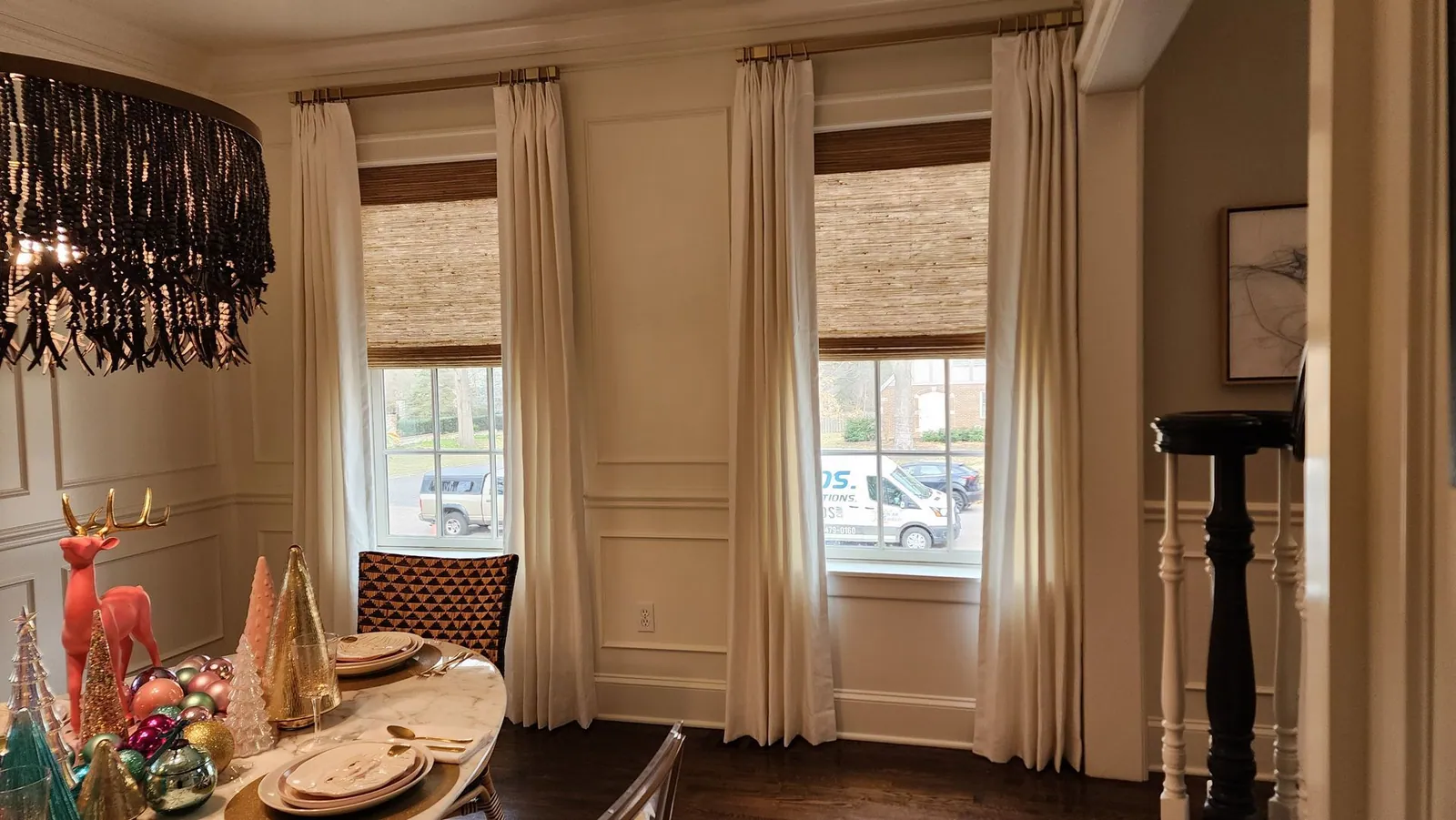 Natural woven shades with drapery panels in a dining room