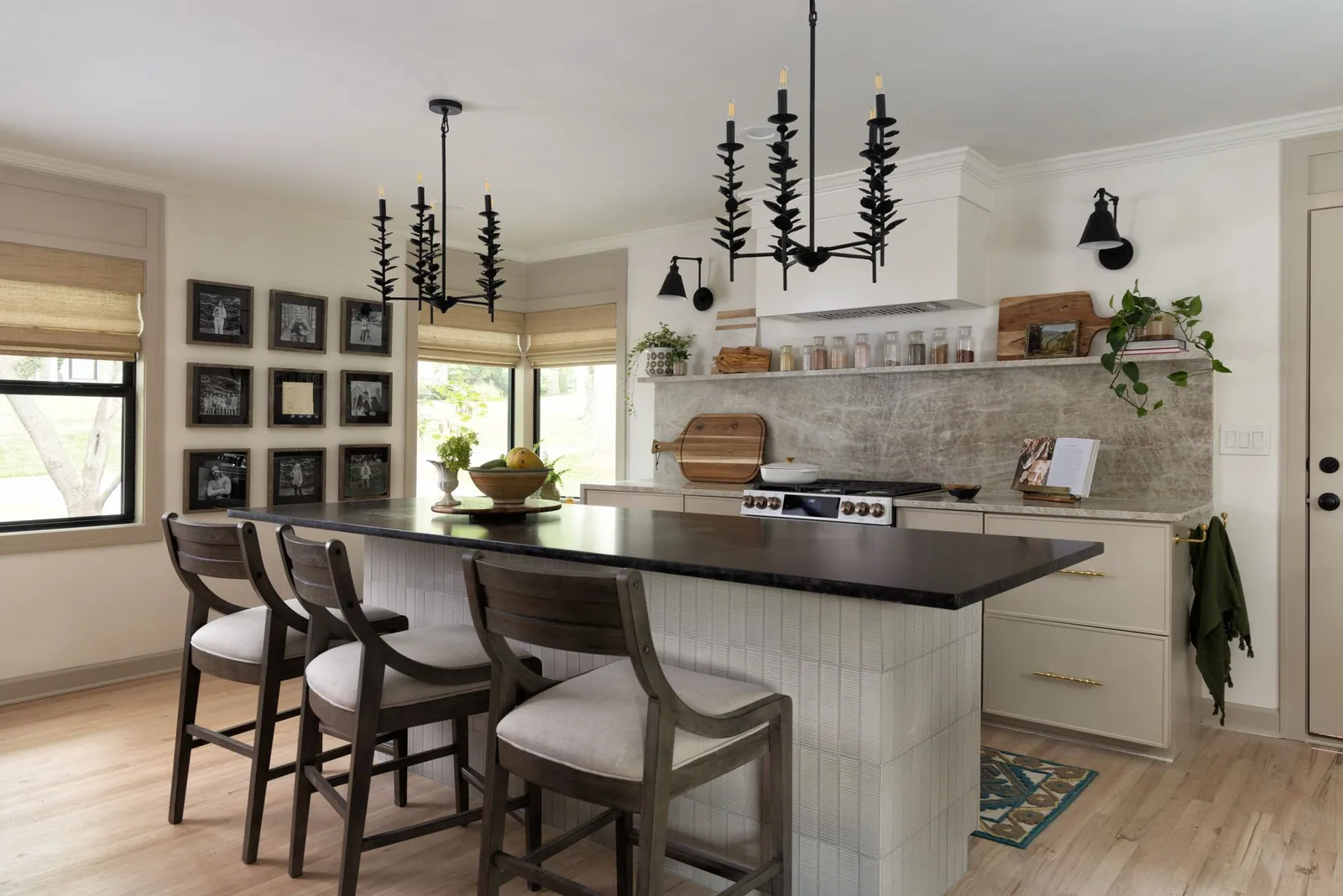 Natural woven shades over the windows of a kitchen with an island