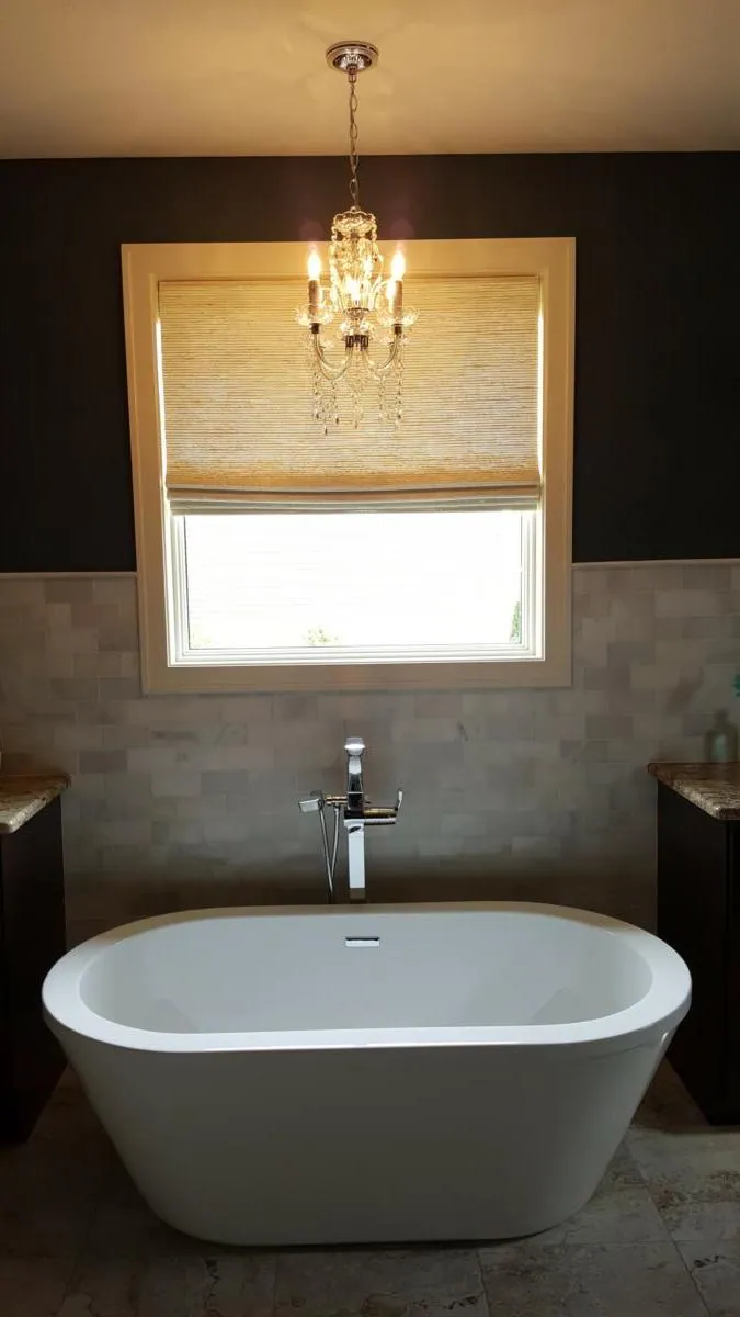 Natural Woven Shade in a bathroom with a freestanding tub, installed by Solar Shield Blinds
