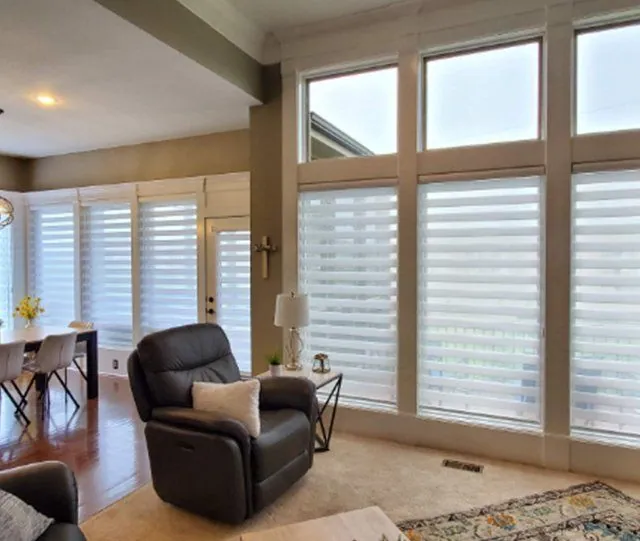 Sheer shades on a wall of tall windows in a living room