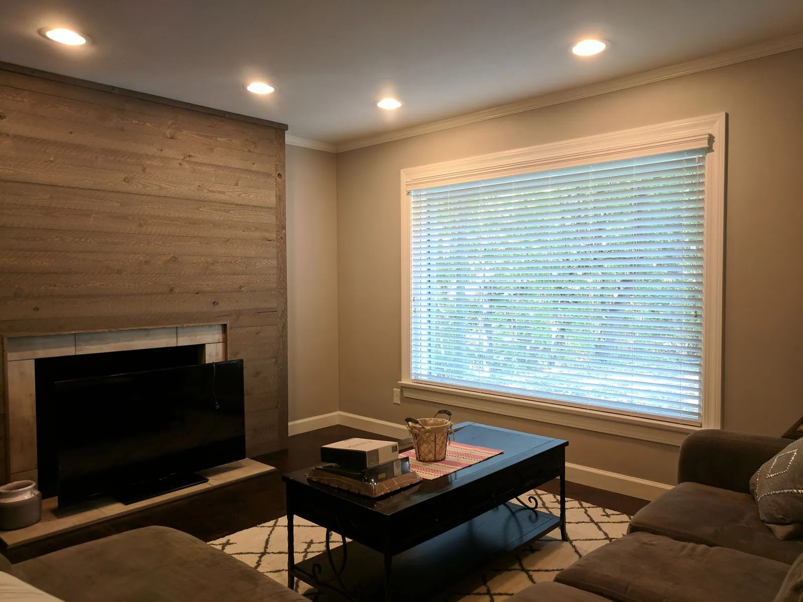 Blinds under a matching valance on a family room window, installed by Solar Shield Blinds