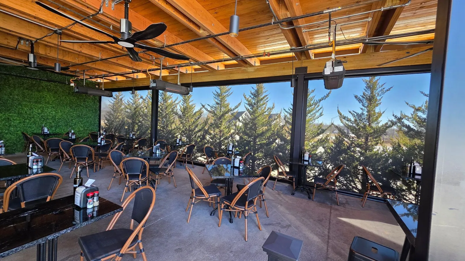 Exterior shades closed around the covered patio at Meddy's, with overhead heaters running