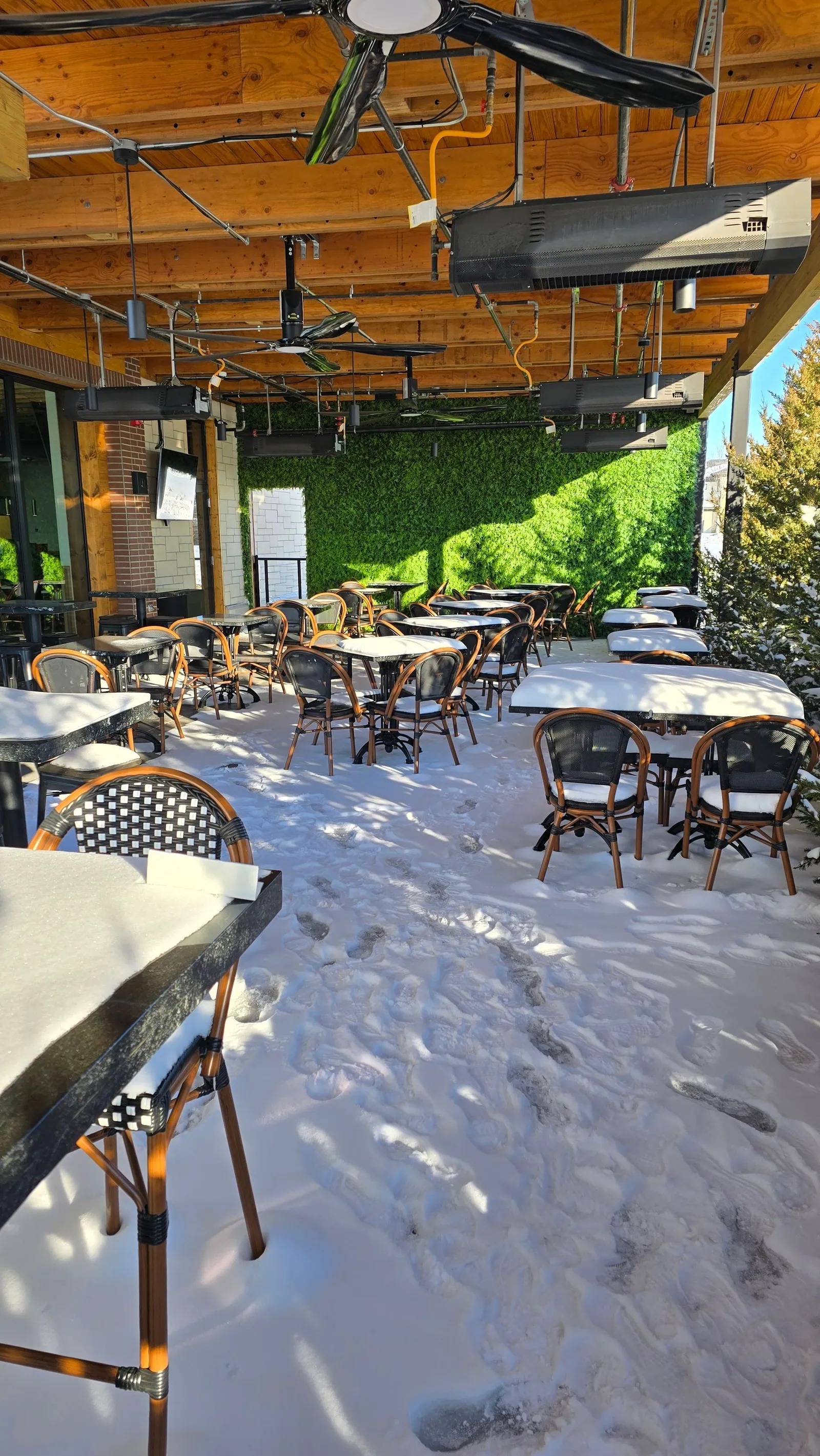 Snow across the Meddy's patio tables before the install