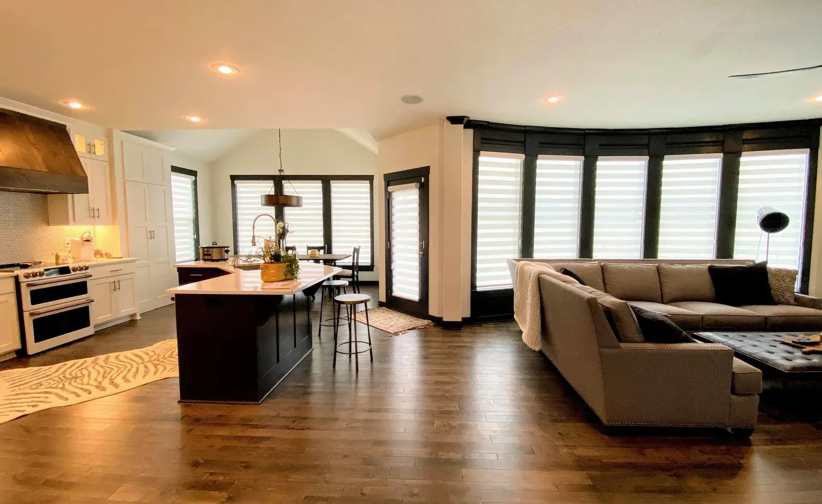 Banded shades across the kitchen windows and the door out to the deck