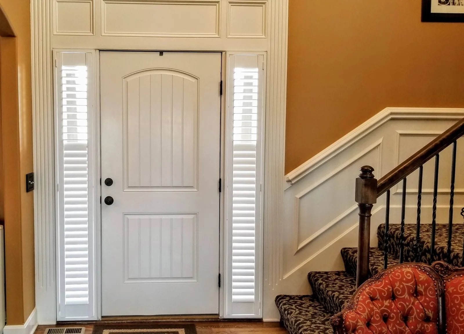Plantation Shutters on both sidelights with the louvers tilted down