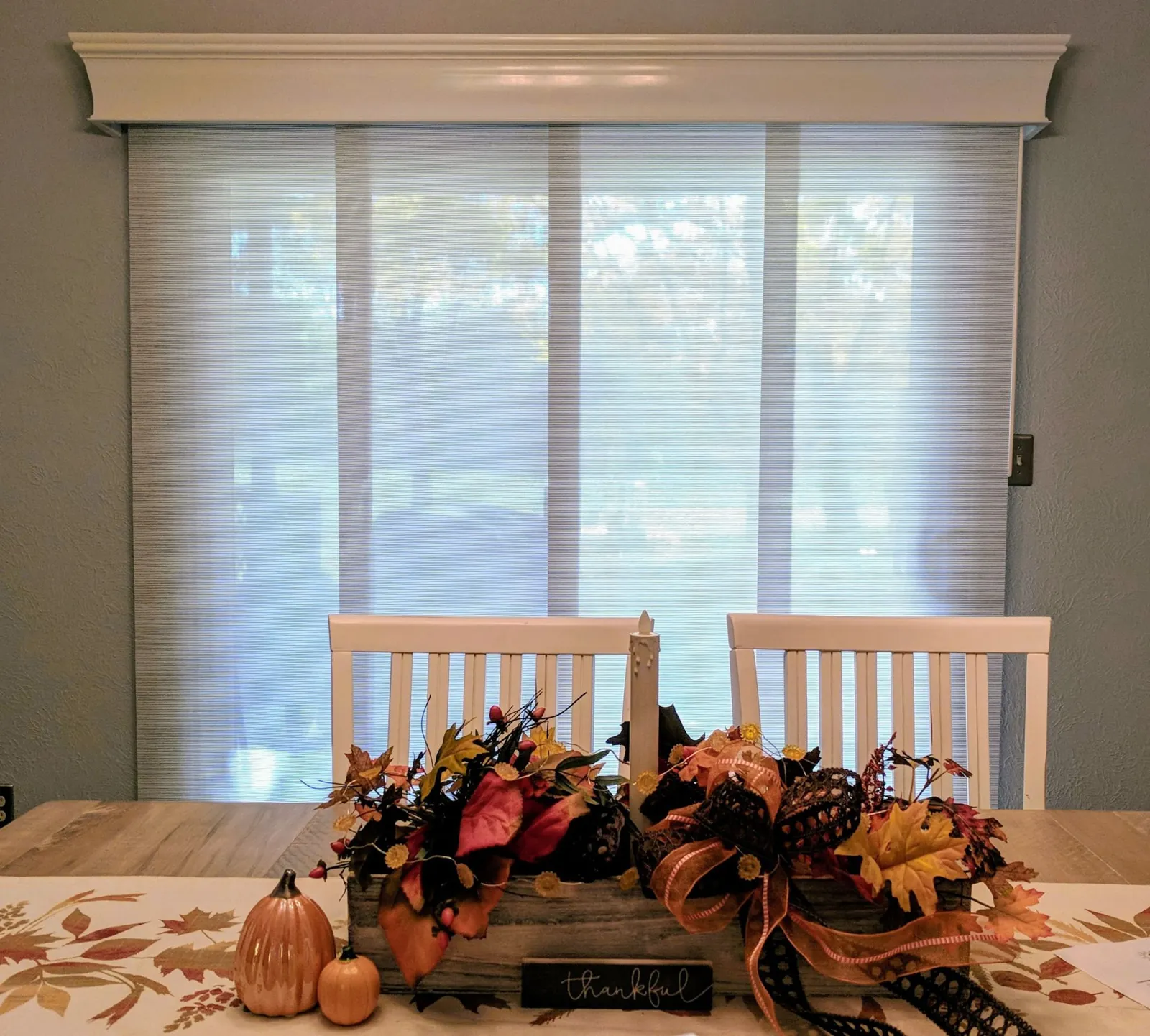 Panel Tracks under a white cornice across a dining room sliding glass door