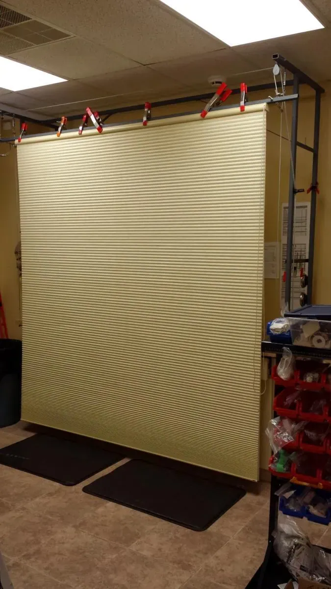 A honeycomb shade clipped onto the rack at the shop