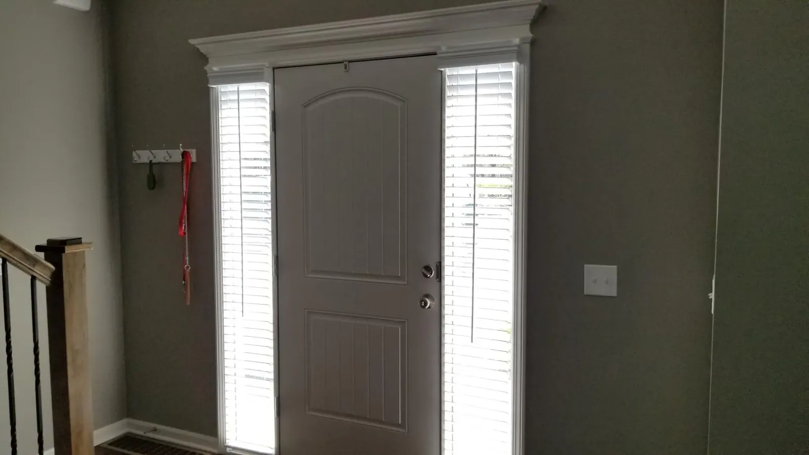 White blinds on both sidelights of a gray front door