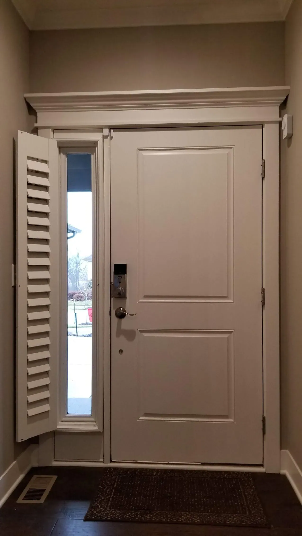 A sidelight shutter panel swung open on its hinges