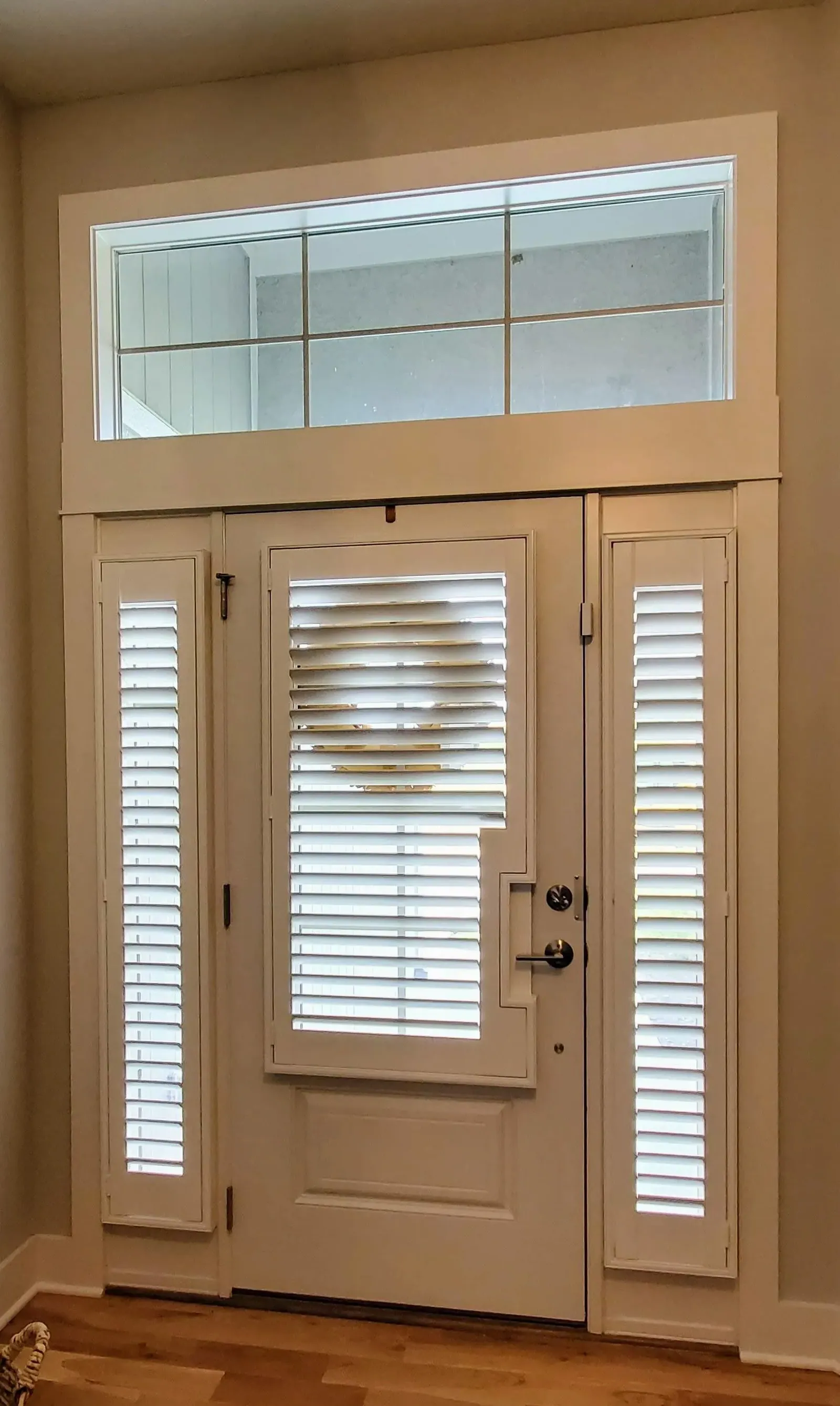 Shutters on the door glass and both sidelights, with the transom left clear