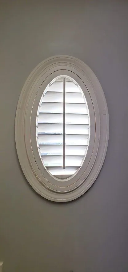 Oval plantation shutter with the louvers tilted open
