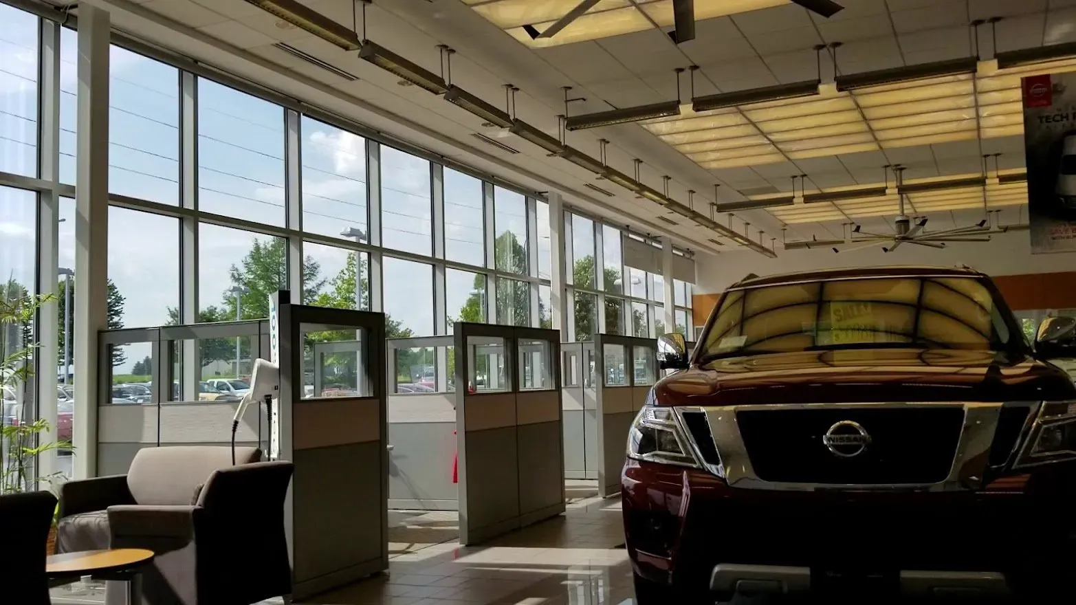Roller Shades on the showroom windows of a car dealership, installed by Solar Shield Blinds