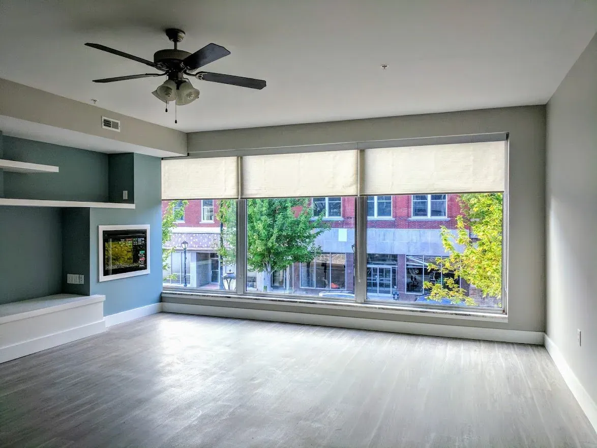 Roller Shades on the street facing windows of a renovated commercial space, installed by Solar Shield Blinds