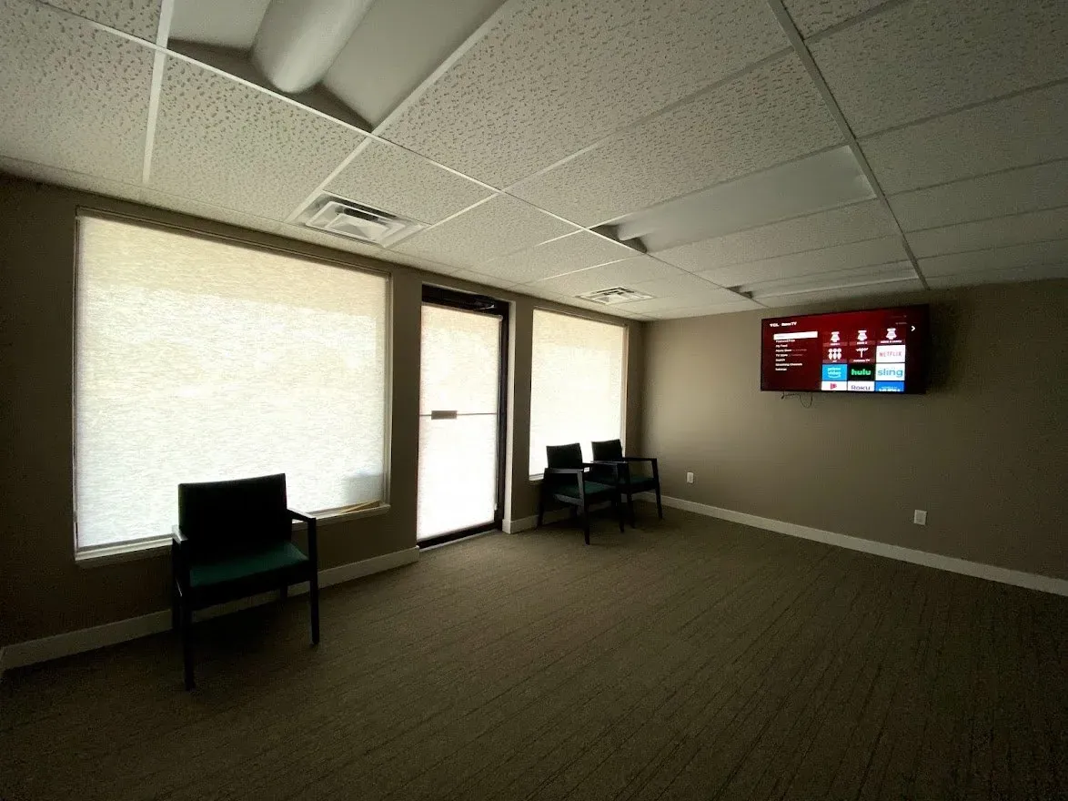 Roller Shades in an office waiting room, installed by Solar Shield Blinds