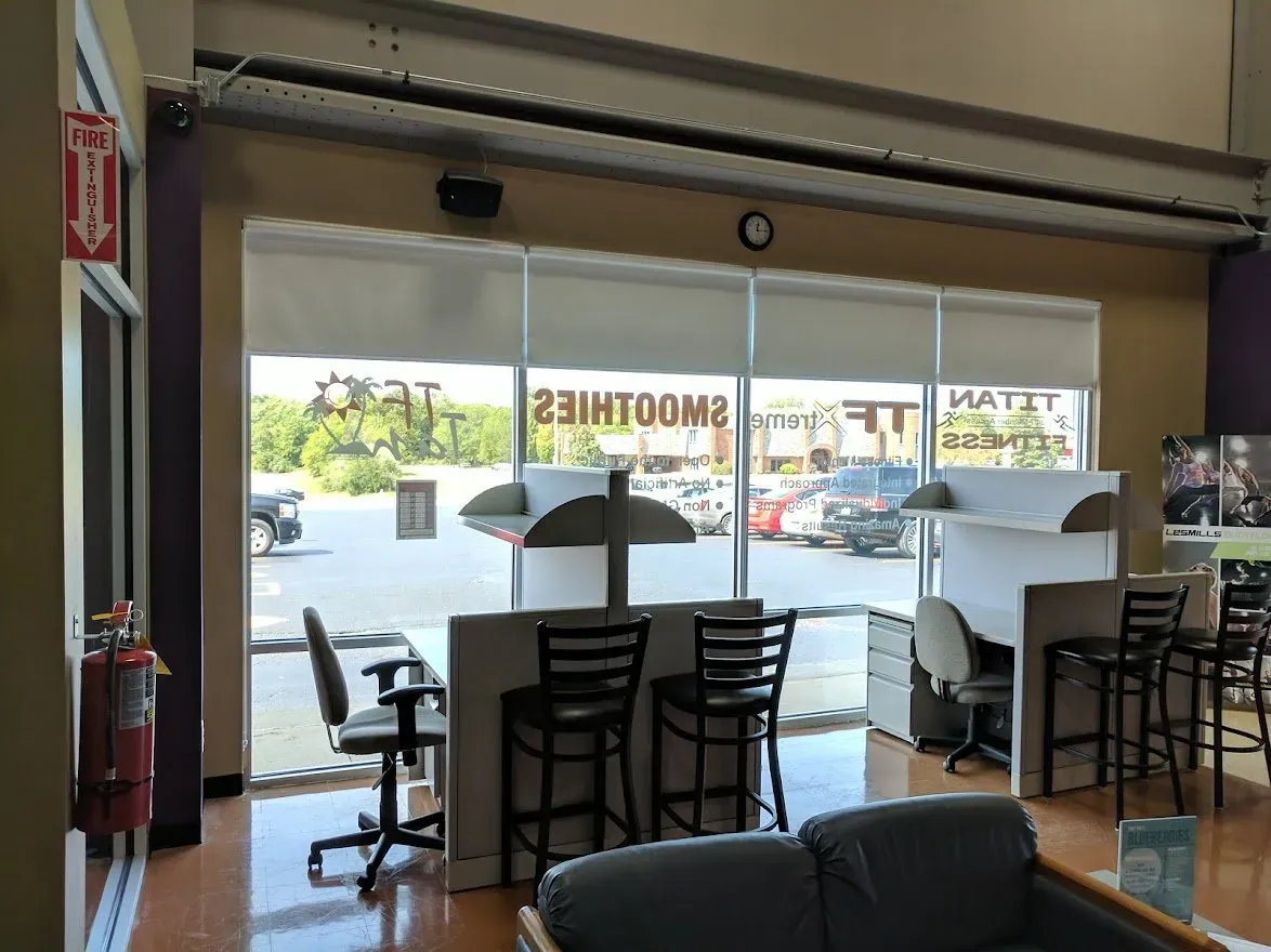 The same storefront with the roller shades raised to show the view out