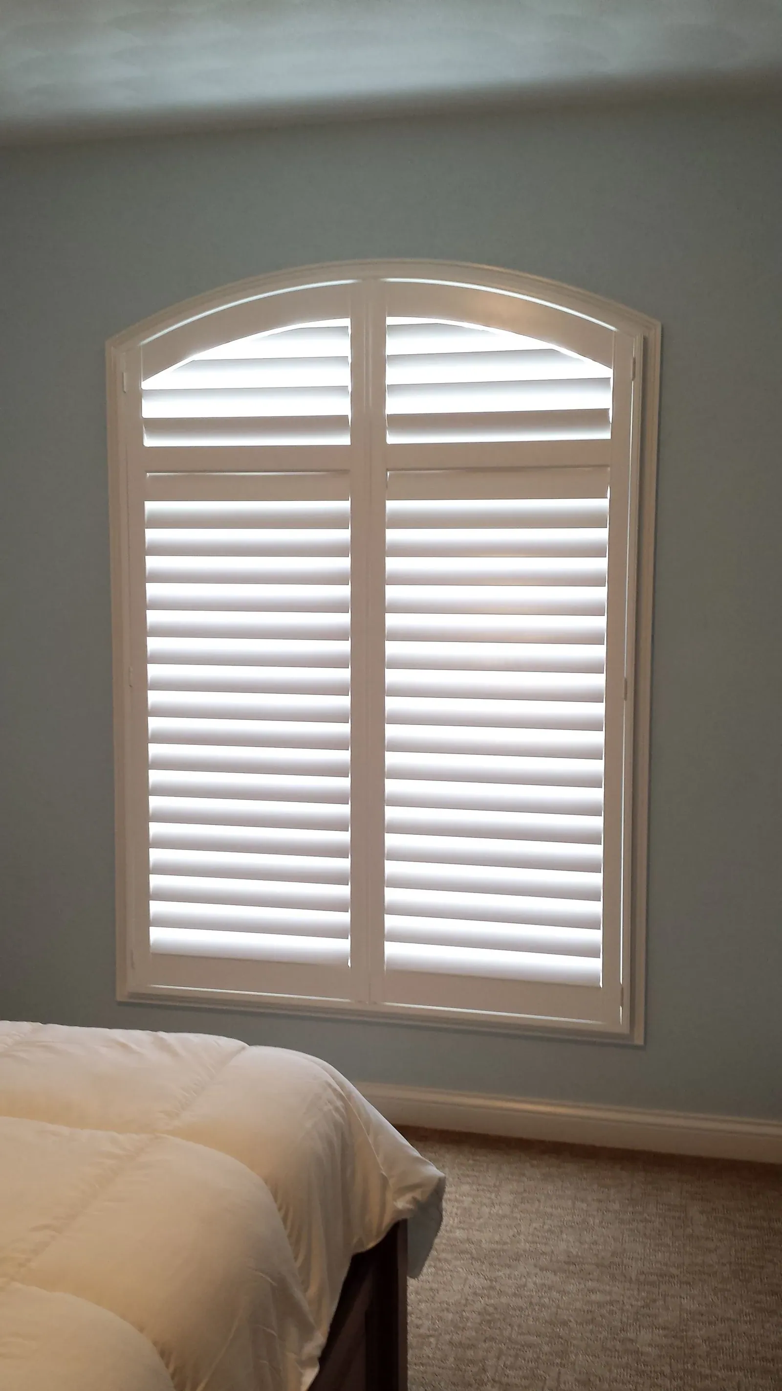 A custom shaped window treatment fitted to a specialty opening