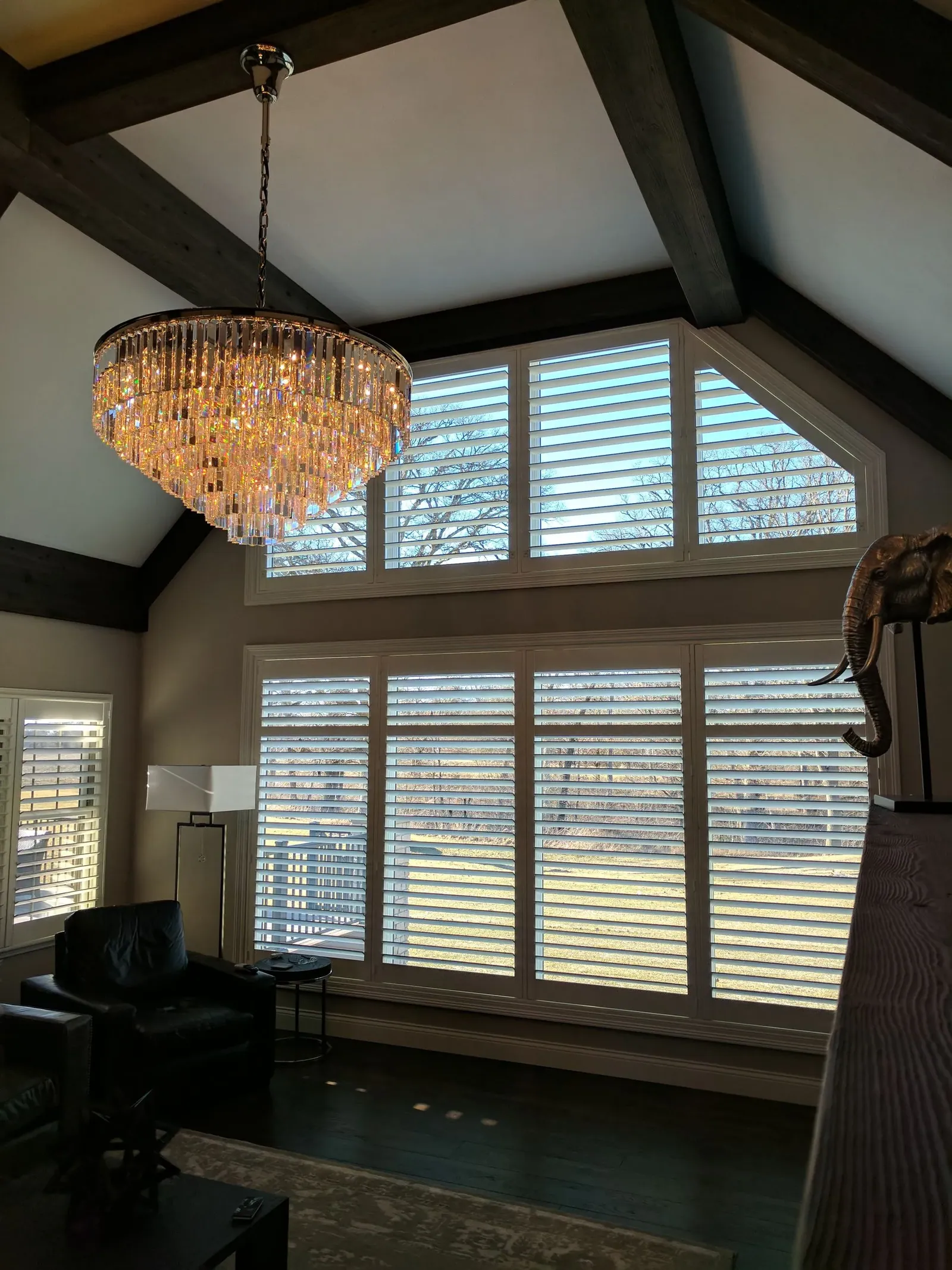Specialty shape shutters fitted under a vaulted ceiling